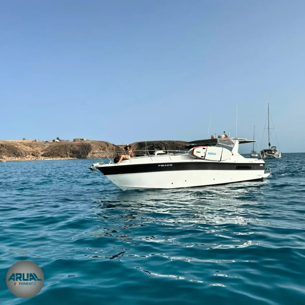 Nuestra embarcación ARUAL navegando por la costa sur de Lanzarote, mientras los clientes disfrutan el momento.